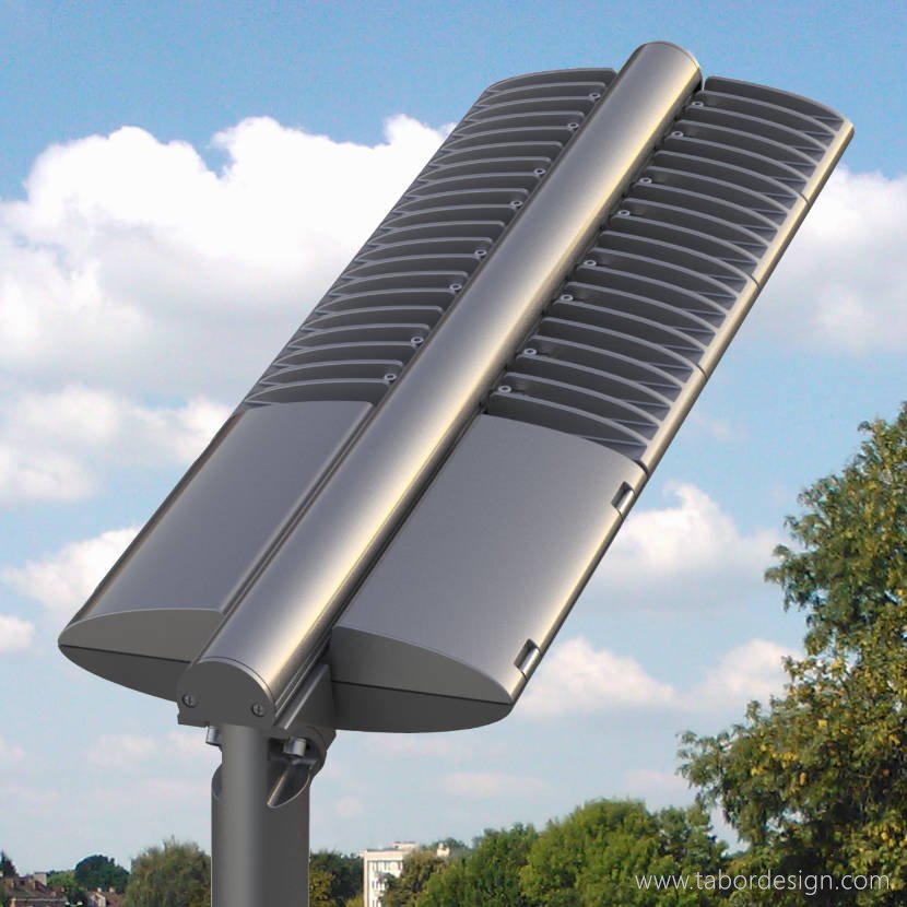 Modułowa oprawa uliczna na pionowym słupie oświetleniowym. W tle pogodne niebo i zieleń drzew.